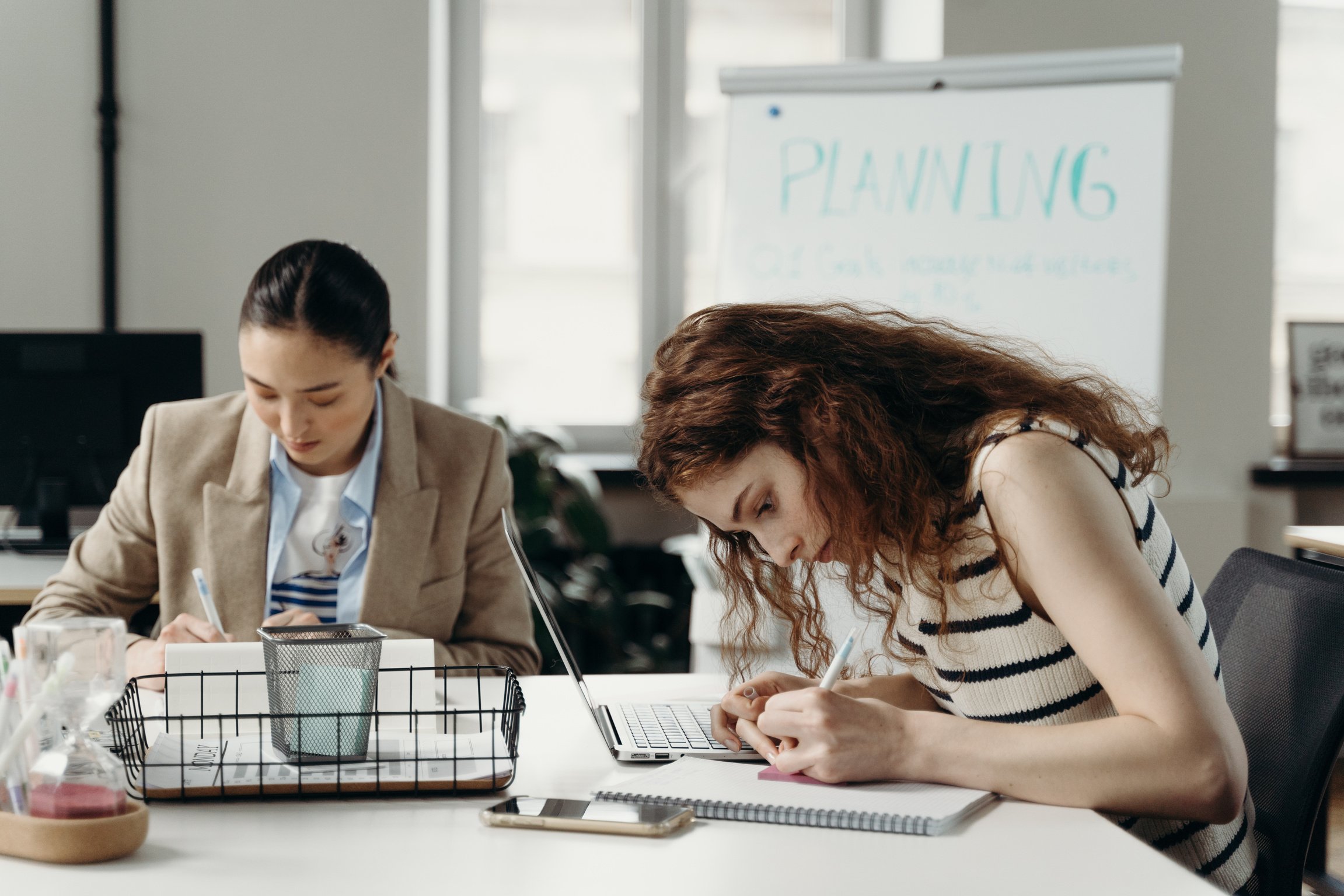 Woman Writing on a Notepad